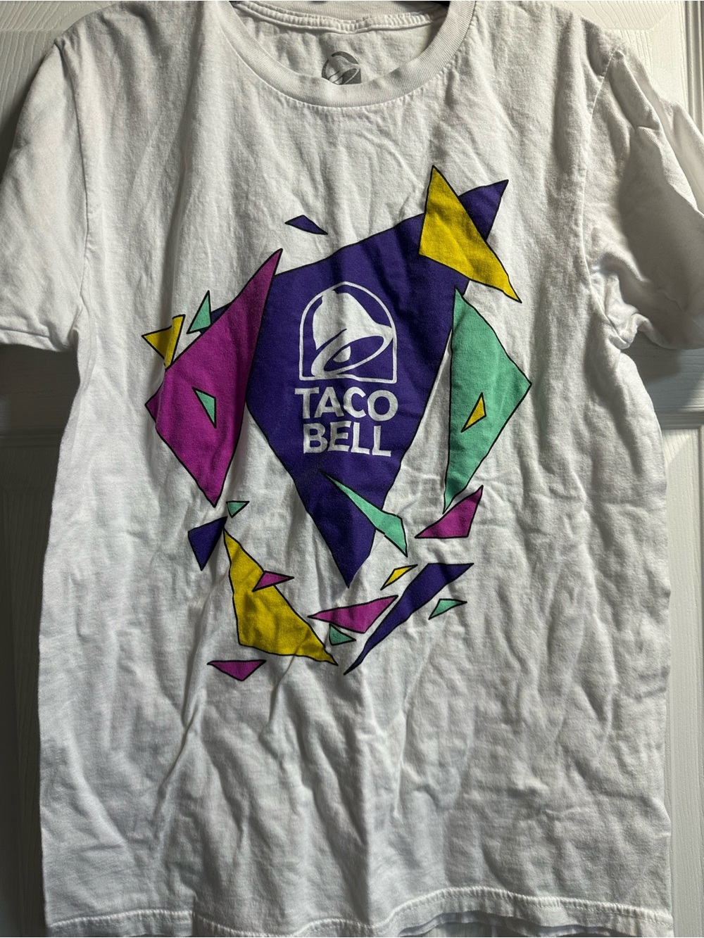 Taco Bell White Graphic Logo Tee with Purple, Yellow & Teal Geometric Art